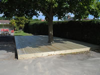 A neat softwood deck covering a patch of unuseable ground.